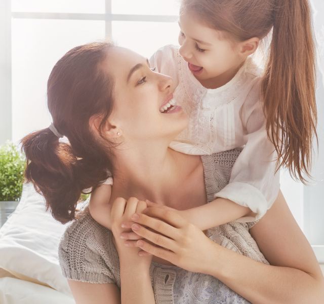 Mother and daughter laughing